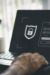  Online security threat and fraud. a scammer with cell phone and laptop. Bank account security.