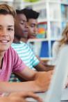 Students using laptop, digital tablet in library